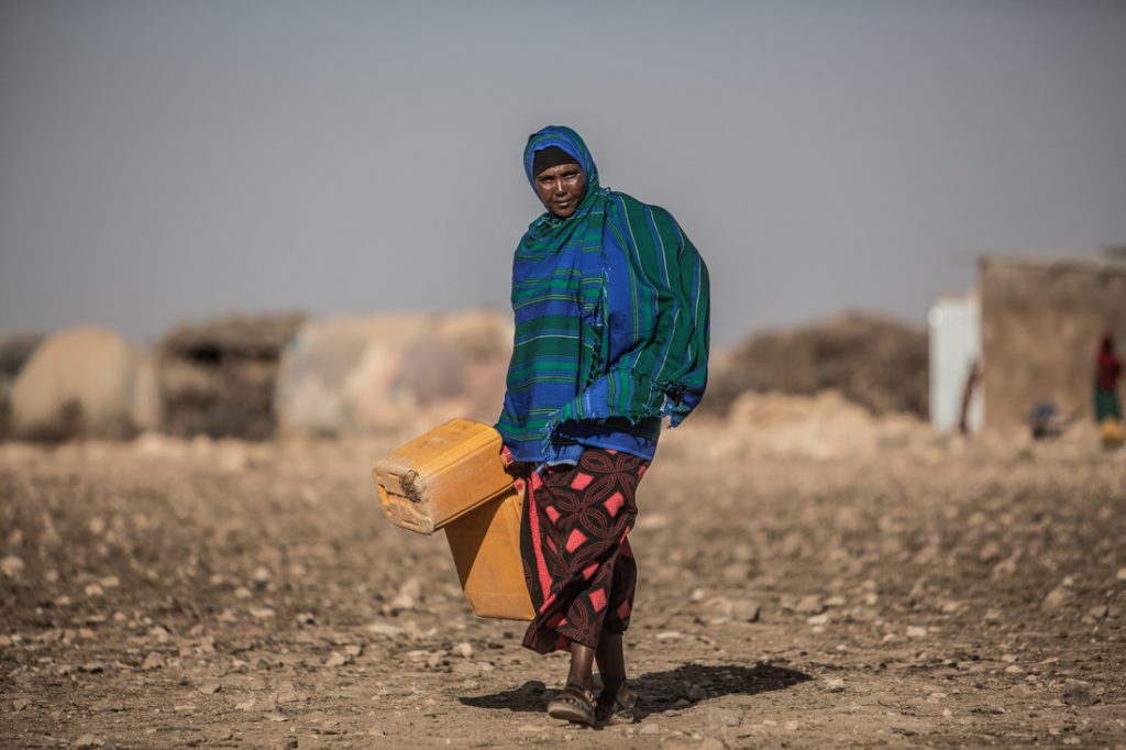 Woman carrying jerry can